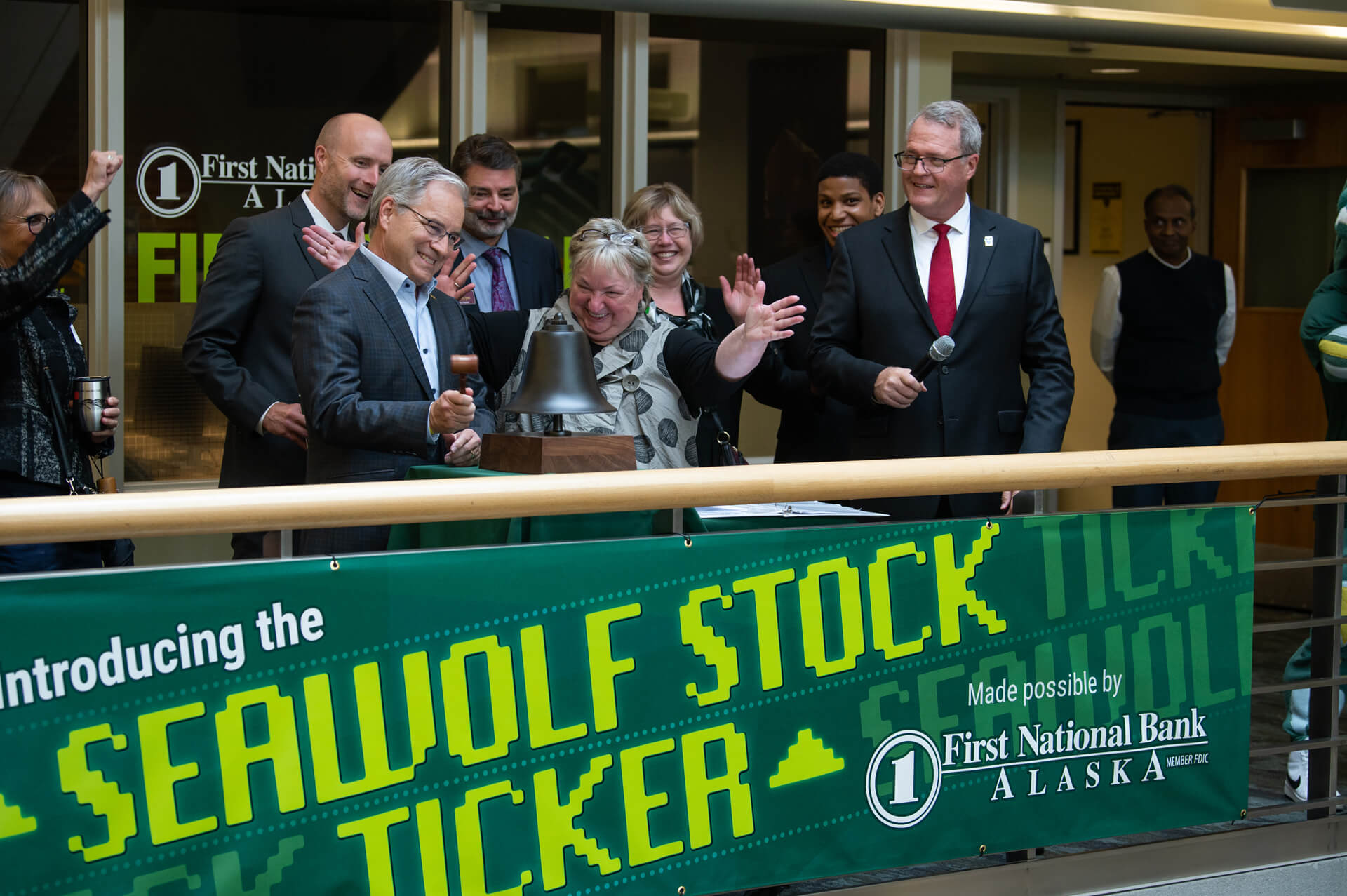 Chancellor Sean Parnell rings a bell to dedicate the new Seawolf Stock Ticker