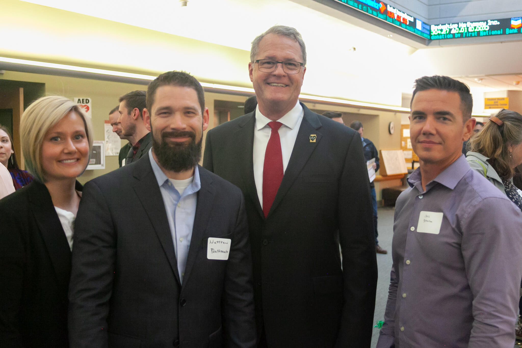 Emily Blattmachr, BA ‘09 English; Matthew Blattmachr, BBA ‘08 Global Logistics; John Nofsinger, Dean of the College; and Chris Yelverton, Key Bank, at the College of Business and Public Policy Showcase, August 2022.